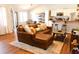 Comfortable living room with a large leather couch, hardwood floors, and an open kitchen at 3065 Wildflower Ln, Snellville, GA 30039