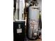 Close-up of mechanical room featuring a furnace and water heater at 3065 Wildflower Ln, Snellville, GA 30039