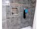 Stylish tiled shower features a built-in niche, decorative accent tiles, and modern shower fixtures at 3065 Wildflower Ln, Snellville, GA 30039