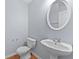 Well-maintained half bathroom featuring a pedestal sink, toilet, and hardwood floors at 695 Georgetown Ct, Jonesboro, GA 30236