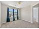 This bedroom features carpeted floors, large windows, and ample natural light at 695 Georgetown Ct, Jonesboro, GA 30236