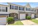 Inviting townhome featuring a one-car garage, brick accents, and a well-maintained lawn at 695 Georgetown Ct, Jonesboro, GA 30236