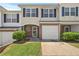 Charming townhome featuring a one-car garage, brick accents, and a well-maintained lawn at 695 Georgetown Ct, Jonesboro, GA 30236