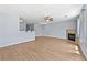 Spacious living room featuring hardwood floors, a fireplace, and lots of light at 695 Georgetown Ct, Jonesboro, GA 30236