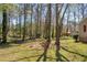 Expansive backyard featuring mature trees and lush greenery, offering a private outdoor retreat at 2073 Lou Ct, Grayson, GA 30017
