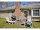 Outdoor patio area, perfect for relaxing and entertaining, with chairs and a grill next to the house at 2073 Lou Ct, Grayson, GA 30017