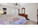 Cozy bedroom features a ceiling fan, soft carpet, and a rustic dresser with a large, ornate mirror at 2073 Lou Ct, Grayson, GA 30017