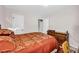 Inviting bedroom with a patterned bedspread, classic wood dresser, and neutral paint at 2073 Lou Ct, Grayson, GA 30017