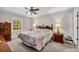 Comfortable bedroom with neutral paint, carpet, window, ceiling fan, and traditional furniture at 2073 Lou Ct, Grayson, GA 30017