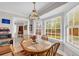 Bright dining area with a round table, large bay window, and a view into the adjacent living space at 2073 Lou Ct, Grayson, GA 30017