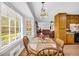 Cozy dining area features wood table, chairs, and natural light from the windows, perfect for enjoying meals at 2073 Lou Ct, Grayson, GA 30017