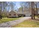 Charming ranch-style home with a well-maintained lawn, mature trees, and a long driveway leading to an attached garage at 2073 Lou Ct, Grayson, GA 30017