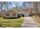 Ranch-style home featuring red shutters, attached garage, mature trees, and well-manicured lawn providing great curb appeal at 2073 Lou Ct, Grayson, GA 30017