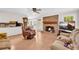 Comfortable living room featuring a brick fireplace, hardwood floors, an open layout, and seamless flow to the kitchen at 2073 Lou Ct, Grayson, GA 30017