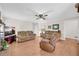 Bright living room featuring hardwood floors, neutral-toned sofas, and ample natural light, creating a cozy atmosphere at 2073 Lou Ct, Grayson, GA 30017