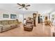 Spacious living room with hardwood floors, comfortable sofas, a ceiling fan, and an open layout at 2073 Lou Ct, Grayson, GA 30017