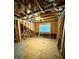 Unfinished attic displaying the frame, window, and flooring at 310 Ellington Dr, Canton, GA 30115
