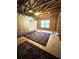 Unfinished attic featuring visible framework, a door, and a window at 310 Ellington Dr, Canton, GA 30115