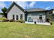 Relaxing backyard features a patio with seating, a bench, and well-kept lawn, ideal for outdoor enjoyment at 310 Ellington Dr, Canton, GA 30115
