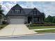 Charming brick home with a manicured lawn, two-car garage, and a welcoming front entrance at 310 Ellington Dr, Canton, GA 30115