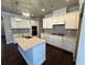 Bright kitchen with white cabinetry, granite countertops, a center island, and stainless steel appliances at 310 Ellington Dr, Canton, GA 30115
