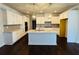 Beautiful kitchen with white cabinets, granite countertops, a central island, and modern pendant lighting at 310 Ellington Dr, Canton, GA 30115