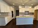 Spacious kitchen with white cabinets, granite countertops, center island, and stainless steel appliances at 310 Ellington Dr, Canton, GA 30115