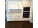 Bright kitchen features stainless steel appliances, subway tile backsplash, and white cabinets at 310 Ellington Dr, Canton, GA 30115
