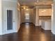Open-concept living area features a large island, modern lighting, and hardwood floors at 310 Ellington Dr, Canton, GA 30115