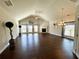 Spacious living room with vaulted ceiling, hardwood floors, fireplace, and large windows at 310 Ellington Dr, Canton, GA 30115