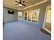 Cozy covered patio has a ceiling fan, mounted tv, and ample natural light at 310 Ellington Dr, Canton, GA 30115