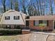 Charming two-story home with brick accents, green shutters, and a cozy, tree-lined front yard at 3334 Spring Meadow Ct, Tucker, GA 30084