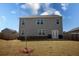 Spacious backyard featuring a privacy fence, a young tree, and the back of a two-story home at 443 Faulkner St, Stockbridge, GA 30281