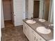 Double vanity bathroom with vinyl flooring and walk-in closet space at 443 Faulkner St, Stockbridge, GA 30281