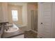 Bright bathroom with a double vanity sink, separate walk-in shower and a tiled floor at 443 Faulkner St, Stockbridge, GA 30281