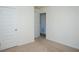 Carpeted bedroom featuring neutral walls, a double door closet and an adjacent door at 443 Faulkner St, Stockbridge, GA 30281