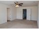 Spacious bedroom featuring neutral walls, carpet, and a ceiling fan with attached lighting fixture at 443 Faulkner St, Stockbridge, GA 30281