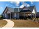 Welcoming community clubhouse with covered porch, manicured landscaping, and pedestrian walkway at 443 Faulkner St, Stockbridge, GA 30281