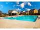 Inviting community pool with clear blue water, surrounded by comfortable lounging spaces and neighborhood homes at 443 Faulkner St, Stockbridge, GA 30281