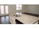 Kitchen island with granite countertop and stainless steel appliances overlooking living area at 443 Faulkner St, Stockbridge, GA 30281