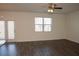 Spacious living room featuring neutral walls, laminate wood floors, and large window at 443 Faulkner St, Stockbridge, GA 30281
