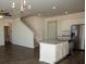 Open-concept living and kitchen area with hardwood floors and stainless steel appliances at 443 Faulkner St, Stockbridge, GA 30281