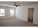 Spacious main bedroom featuring two windows for natural light and neutral carpeting at 443 Faulkner St, Stockbridge, GA 30281