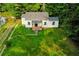 Aerial view of a well maintained home with green surroundings, new roof, and a lush lawn at 451 Collier Ridge Dr, Atlanta, GA 30318