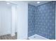 Modern shower features blue patterned tile, silver fixtures, and a sleek shower head at 451 Collier Ridge Dr, Atlanta, GA 30318
