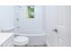 Bright bathroom featuring a white bathtub, toilet, walls, and door, creating a clean and modern look at 451 Collier Ridge Dr, Atlanta, GA 30318
