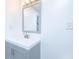 Bathroom with gray vanity, white countertop, mirror, and modern lighting at 451 Collier Ridge Dr, Atlanta, GA 30318