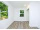A sunny room featuring new flooring, fresh paint, and multiple windows for natural light at 451 Collier Ridge Dr, Atlanta, GA 30318