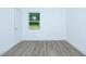 A cozy, bright bedroom with new flooring, a large window and fresh white paint at 451 Collier Ridge Dr, Atlanta, GA 30318