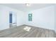 Bright bedroom with white walls, wood floor, and view to modern bathroom at 451 Collier Ridge Dr, Atlanta, GA 30318